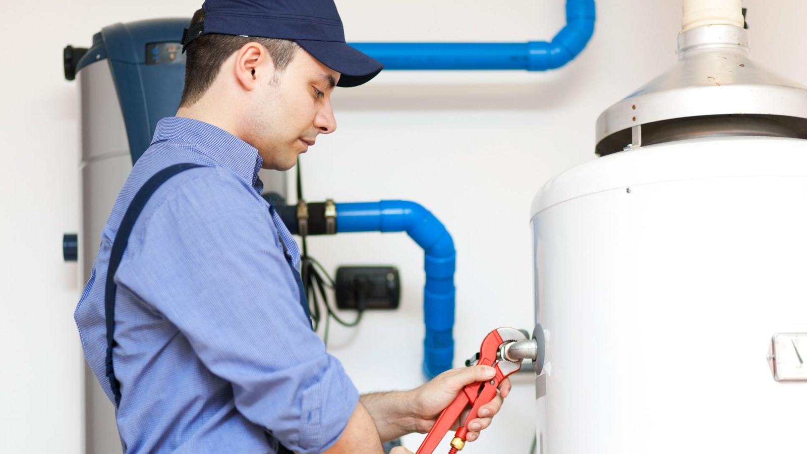 A technician working on a water heater installation