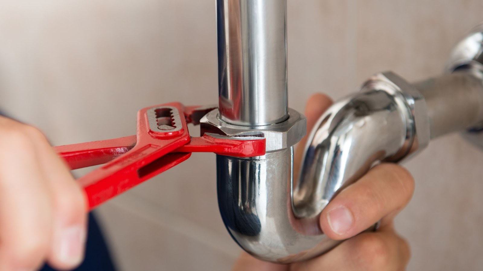 Hands fitting new copper pipework during a repiping job