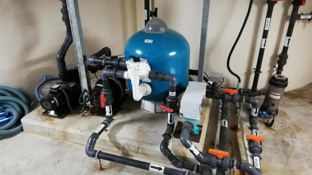 White PVC piping installed in an excavated trench