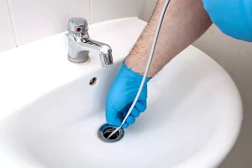 A corroded drain fitting cleared during professional drain cleaning