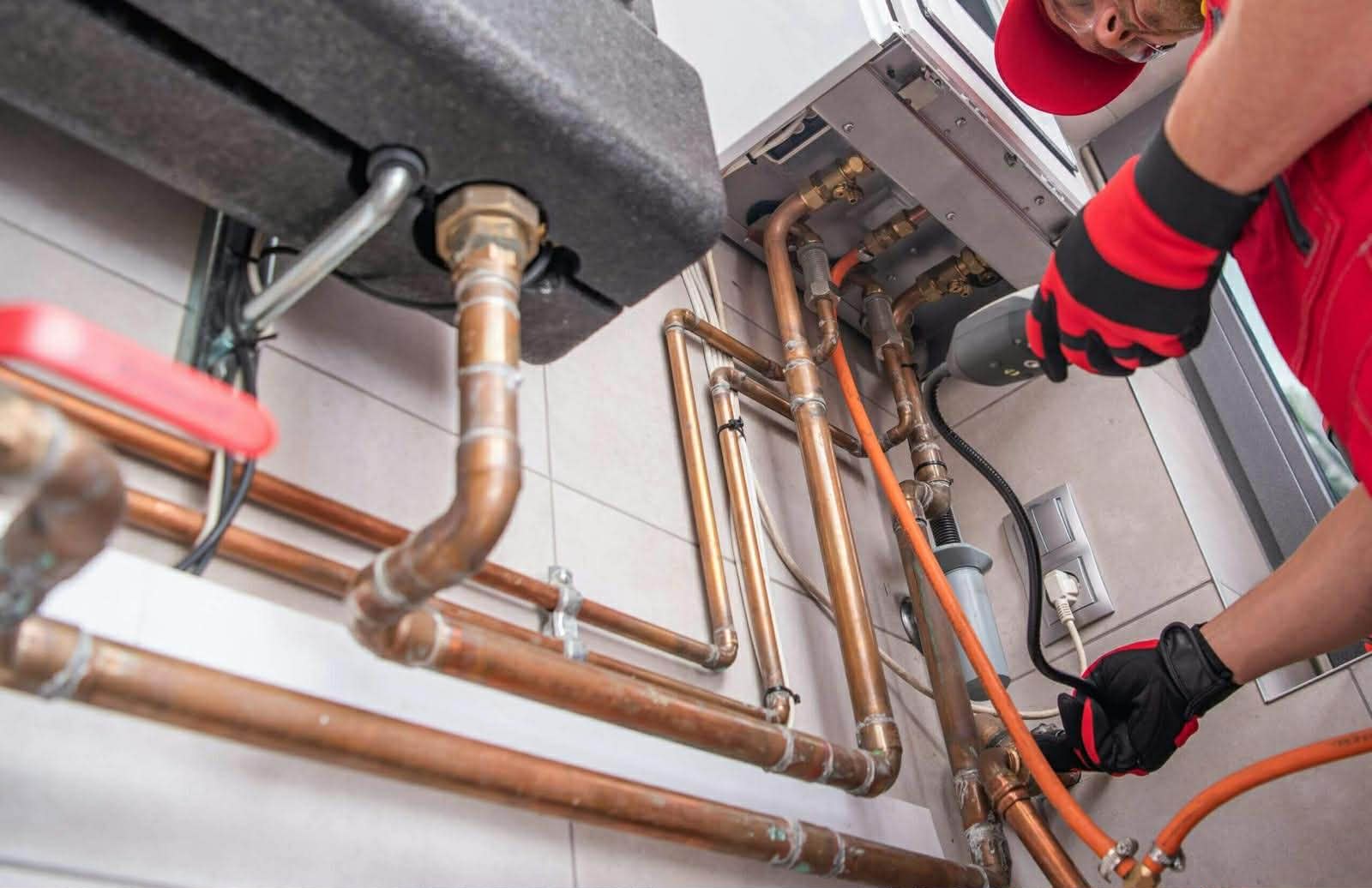 Hands joining pipework on a plumbing job